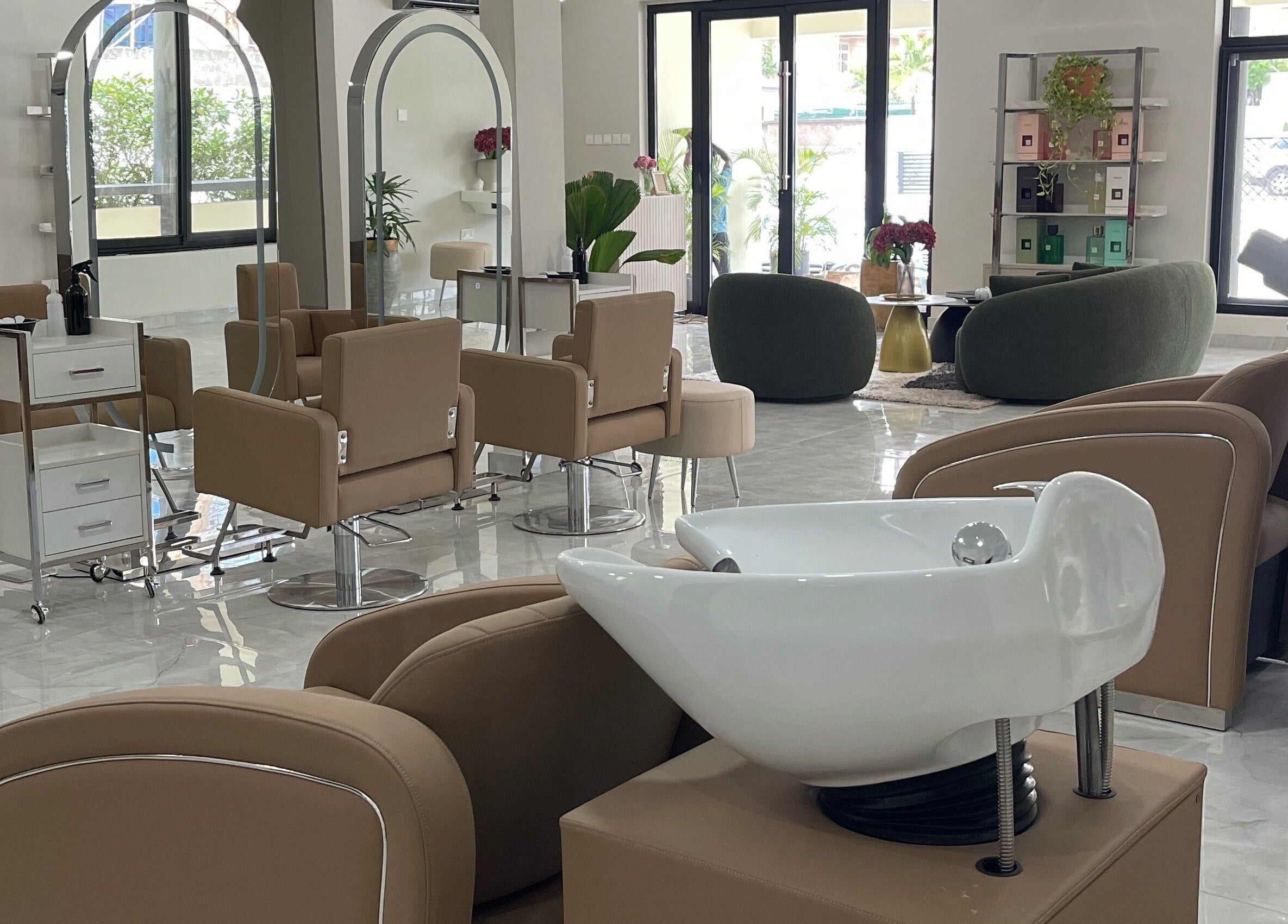 Spacious, modern interior of Kai Beauty Studio in Accra, Greater Accra Region, GH, with stylish seating and mirrors.