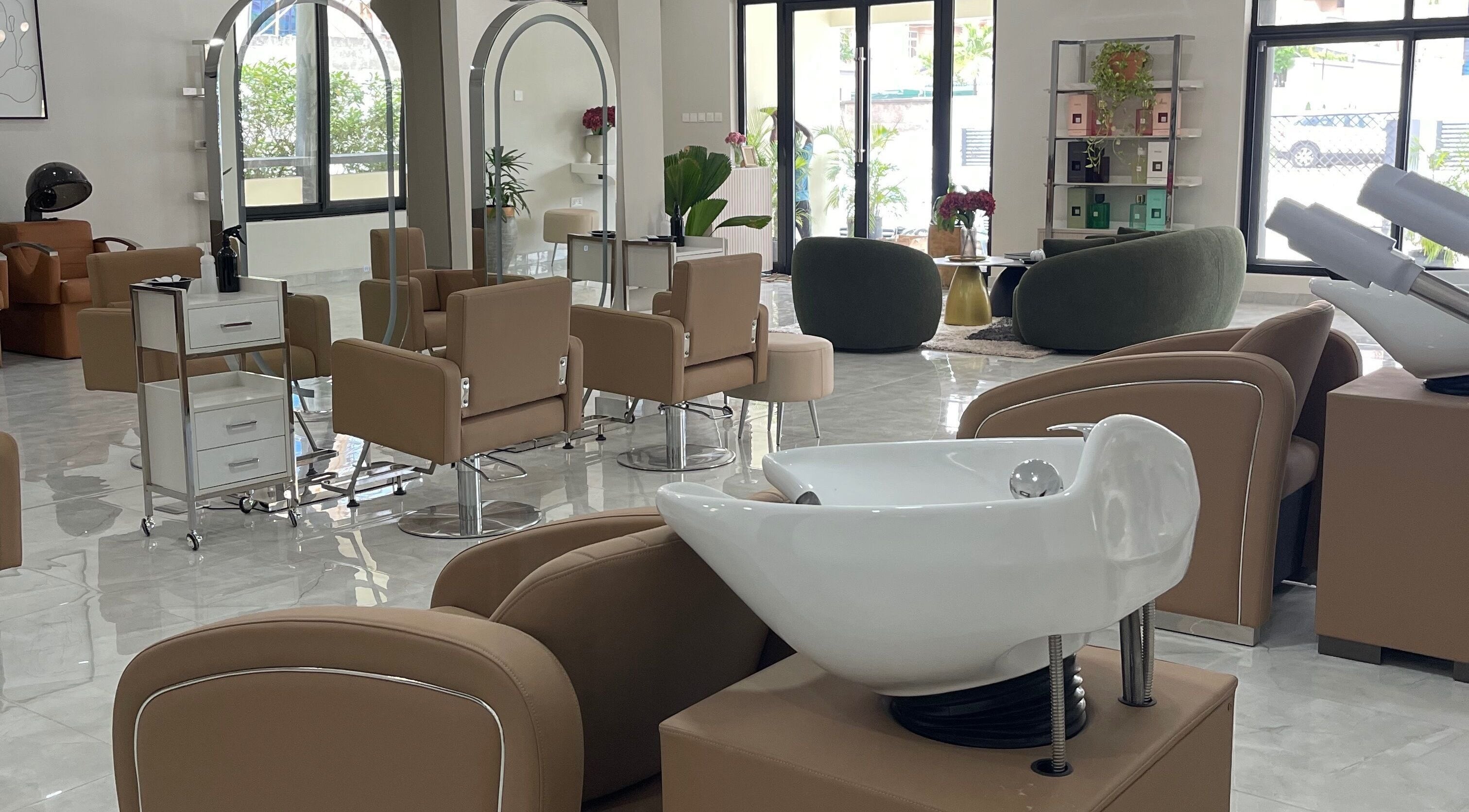 Spacious, modern interior of Kai Beauty Studio in Accra, Greater Accra Region, GH, with stylish seating and mirrors.