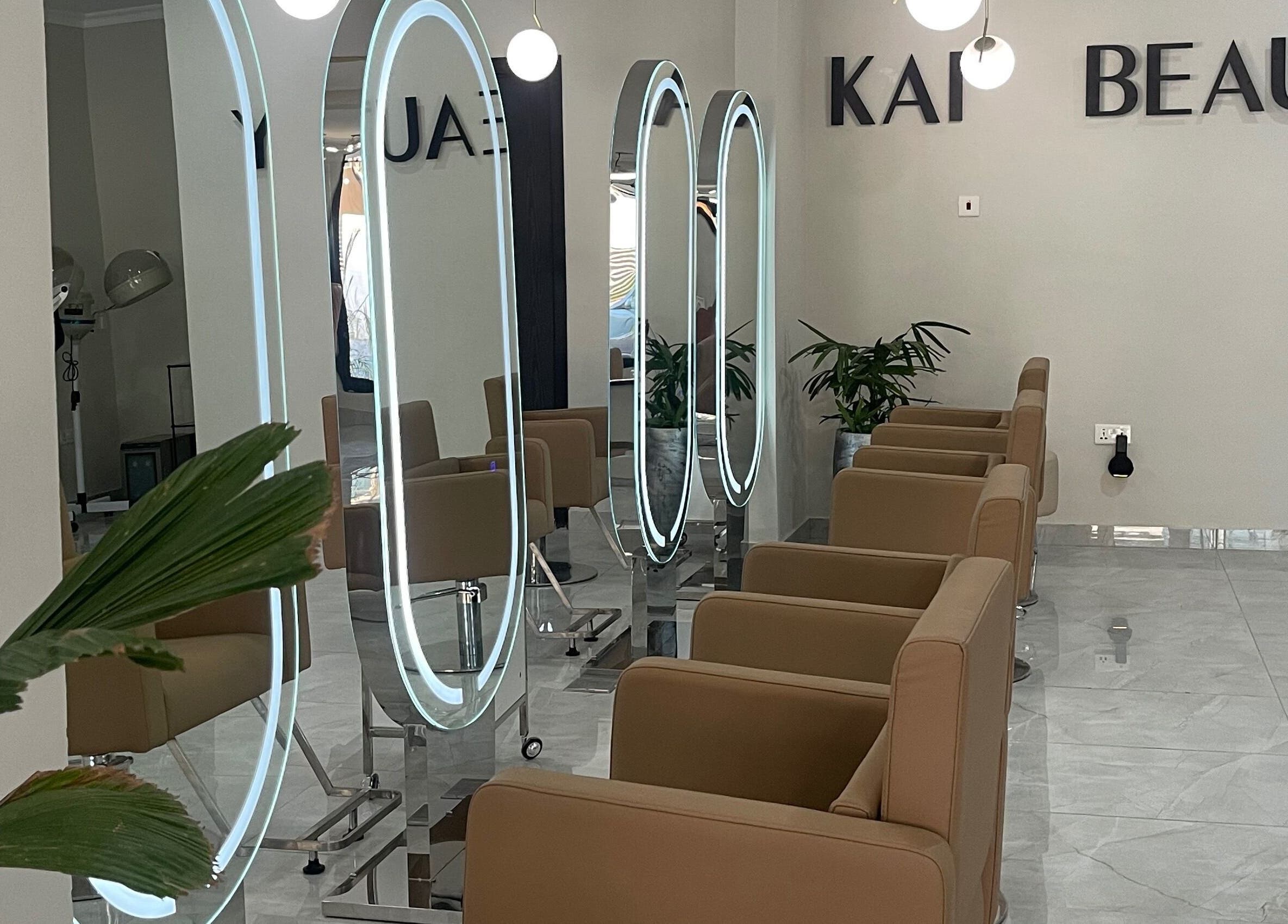 Interior of Kai Beauty Studio in Accra, showcasing stylish chairs and illuminated mirrors.