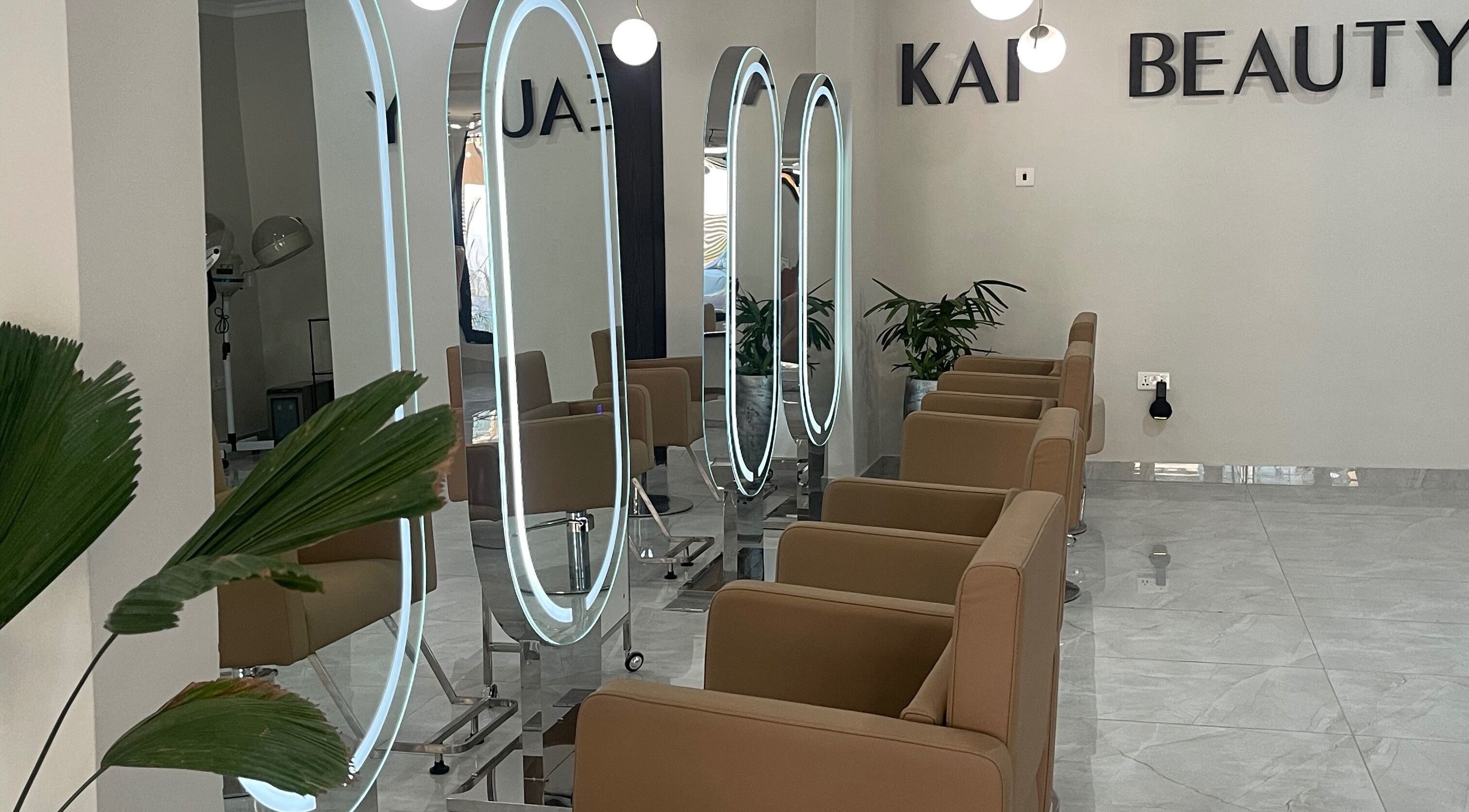 Interior of Kai Beauty Studio in Accra, showcasing stylish chairs and illuminated mirrors.