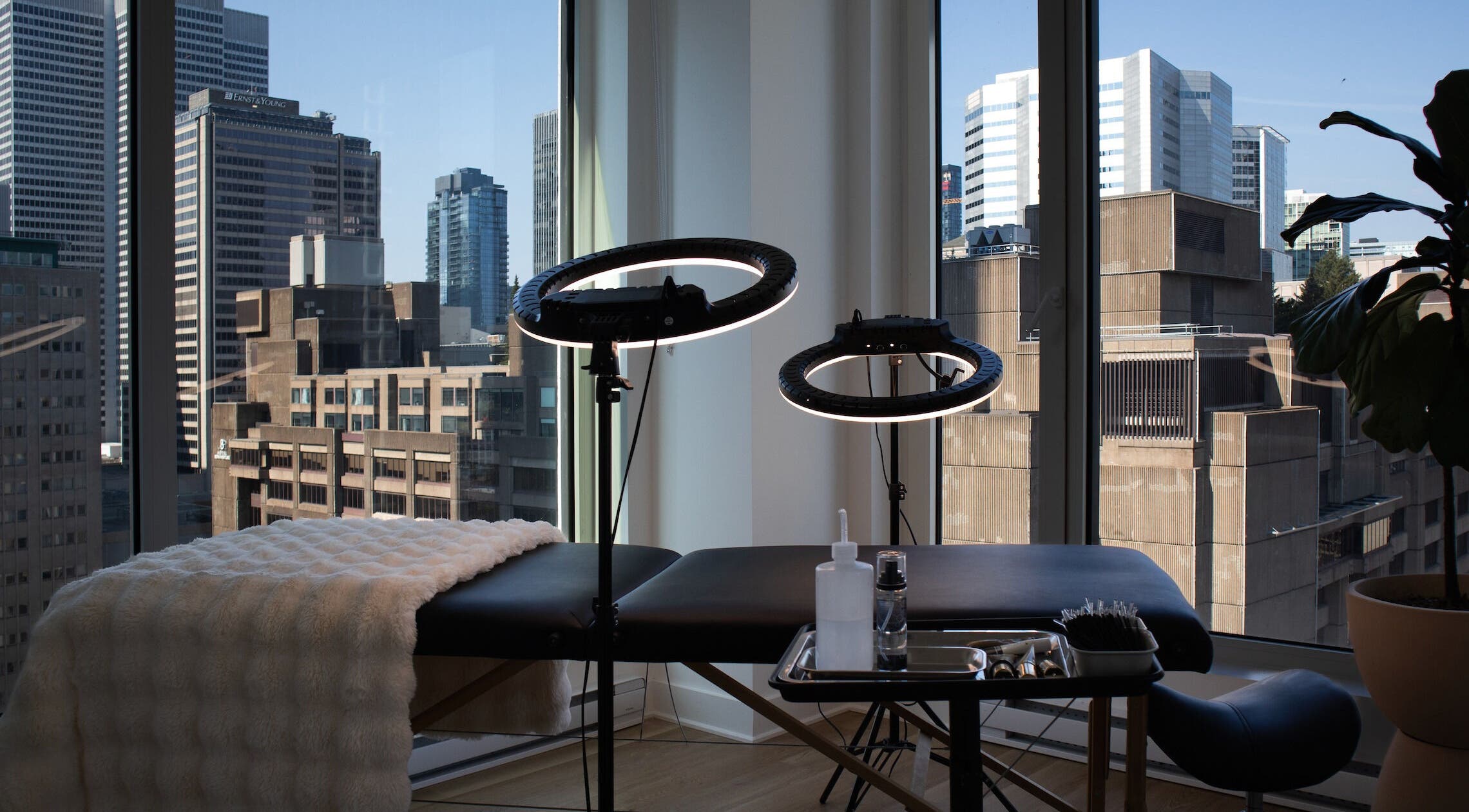 Serene spa room with city view at Muse for Brows in Montréal, Québec, CA, featuring professional ring lights.