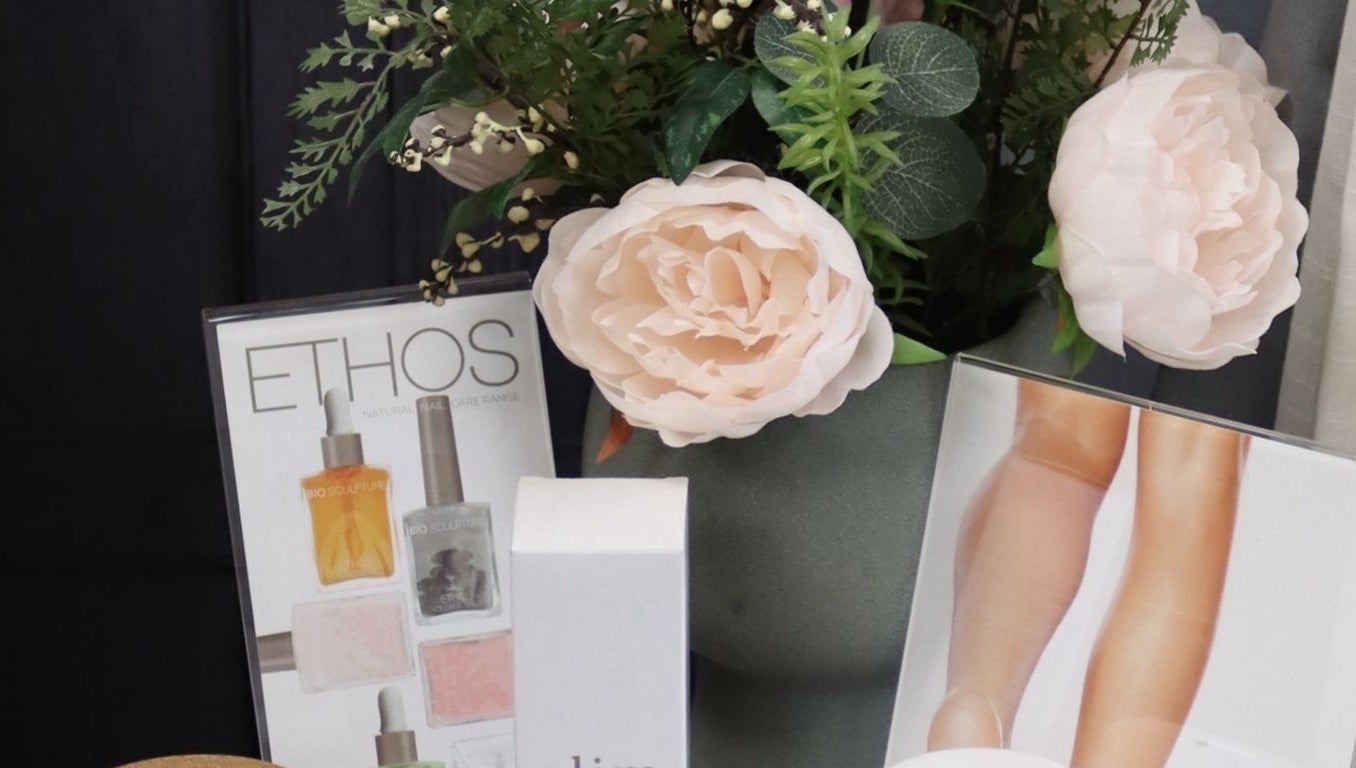 Elegant product display at KL Nail Studio, Newtown, Wales, GB with lush floral decor.