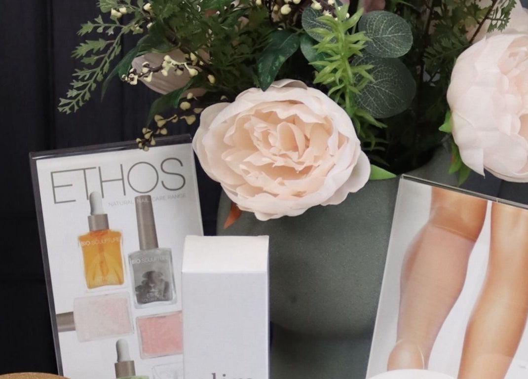 Elegant product display at KL Nail Studio, Newtown, Wales, GB with lush floral decor.