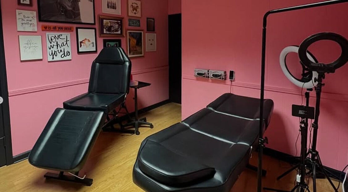 Modern treatment room with pink walls and stylish decor at The Beauty Parlor, Coal City, Illinois, US.