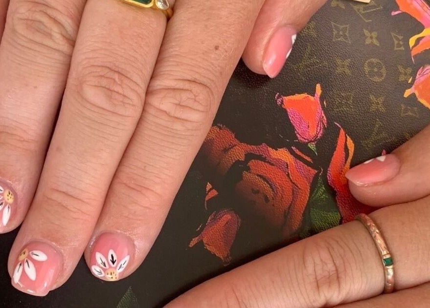 Elegant floral nail art at Cutie Pai Nails, Bali, Bali, ID, showcasing intricate daisy designs on pastel pink nails.