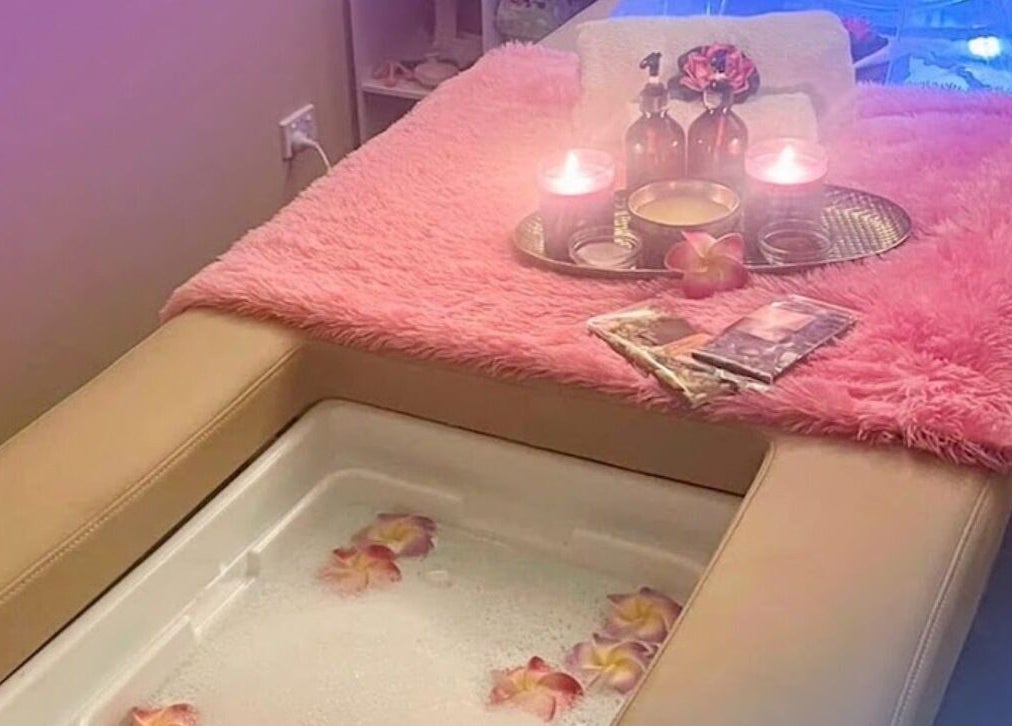 Relaxing spa setting at Signature Massages and Spa, Brighton, South Australia, AU with candles and flowers.