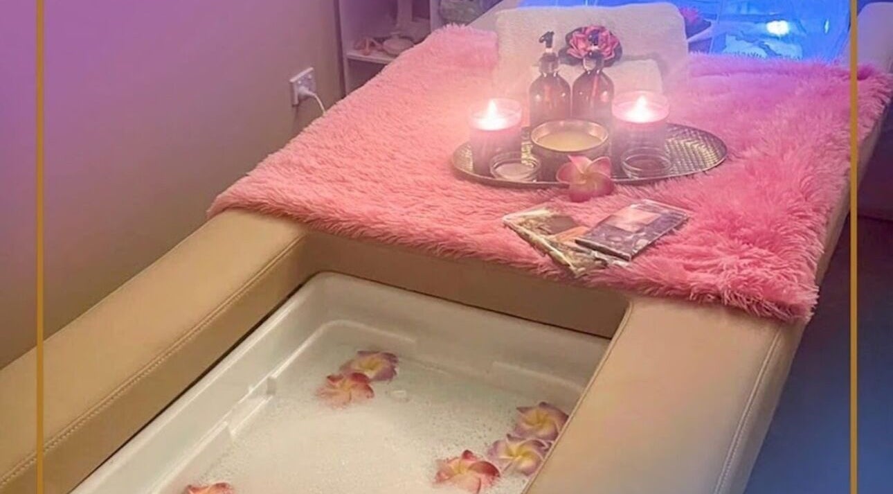 Relaxing spa setting at Signature Massages and Spa, Brighton, South Australia, AU with candles and flowers.