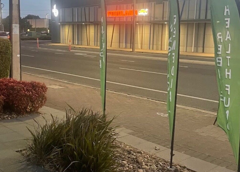 Exterior view of Signature Massages and Spa near street in Brighton, South Australia, AU at dusk.