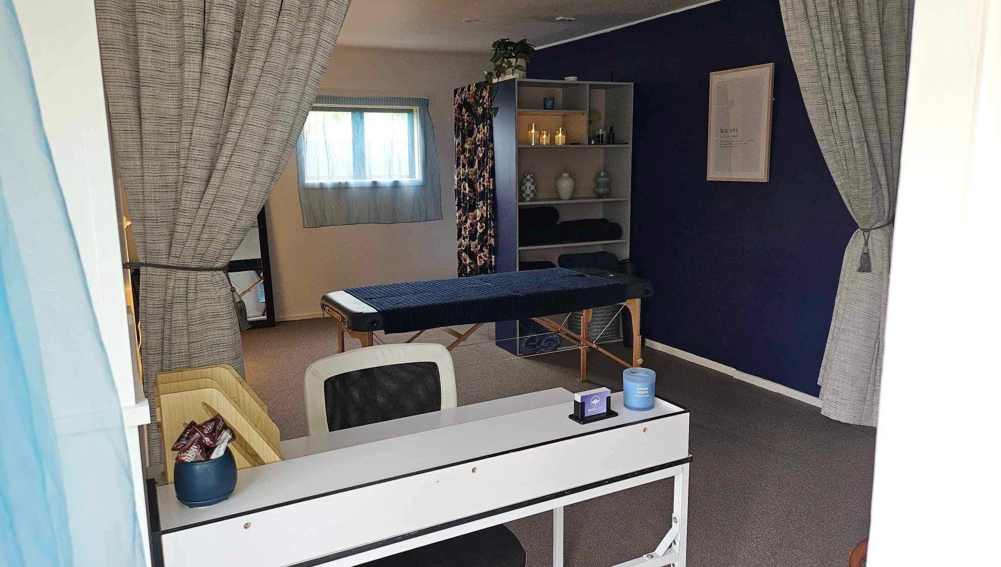 Calming therapy room at Whaitere Ora, Gisborne, Gisborne, NZ, featuring massage table and serene decor.