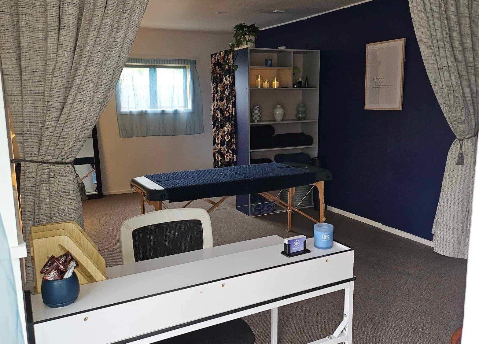 Calming therapy room at Whaitere Ora, Gisborne, Gisborne, NZ, featuring massage table and serene decor.