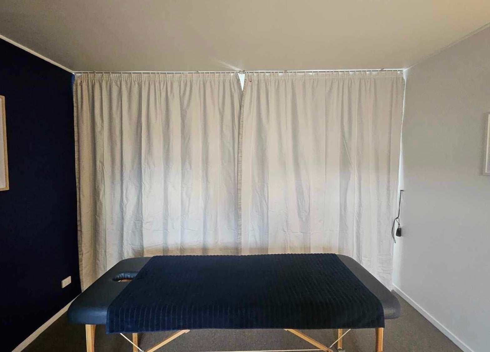 Massage table in serene room at Whaitere Ora, Gisborne, Gisborne, NZ offers a peaceful healing space.