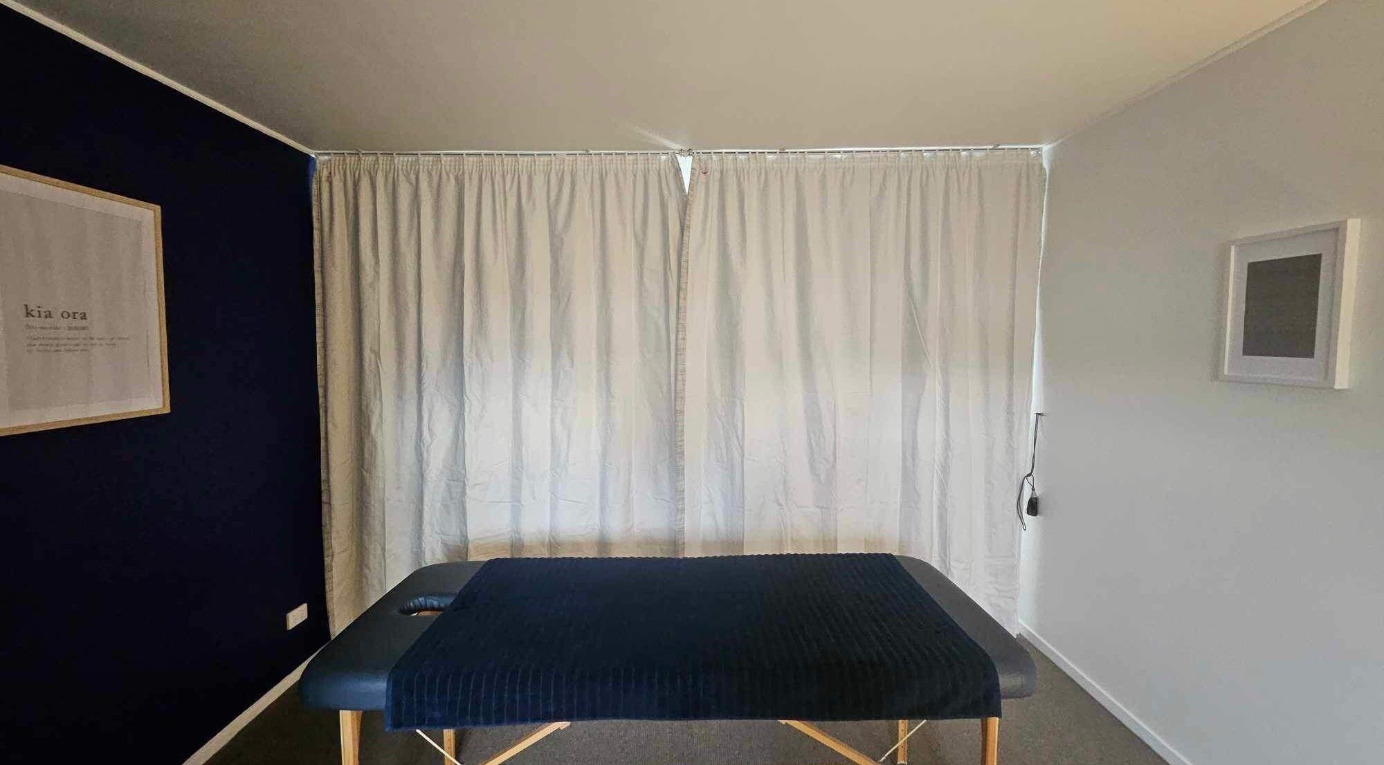 Massage table in serene room at Whaitere Ora, Gisborne, Gisborne, NZ offers a peaceful healing space.