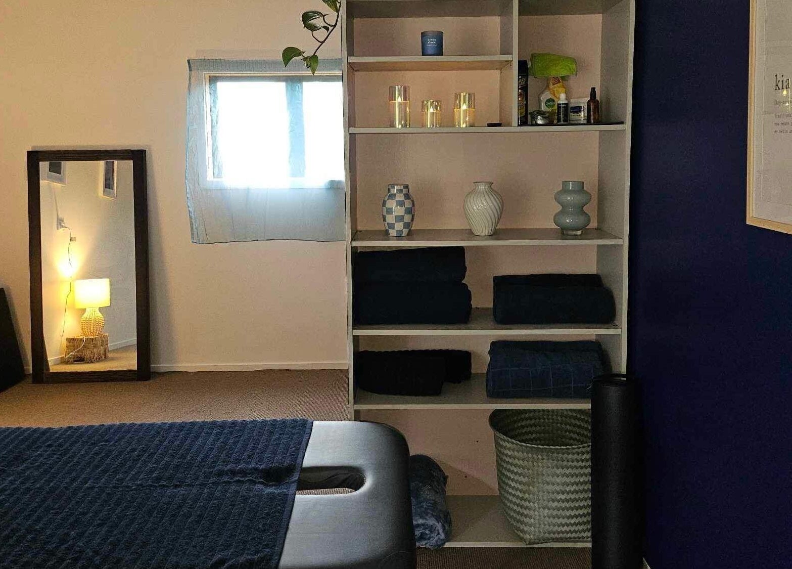 Tranquil massage room at Whaitere Ora, Gisborne, NZ, with cozy decor and calming ambiance.