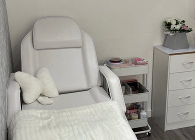 Cozy beauty treatment room at Ella Louise Beautyy, Rochdale, England, GB with plush chair and floral decor.