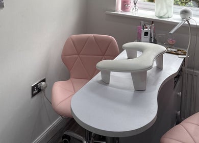 Elegant nail station at Ella Louise Beautyy in Rochdale, England, GB featuring pink chairs and nail tools.