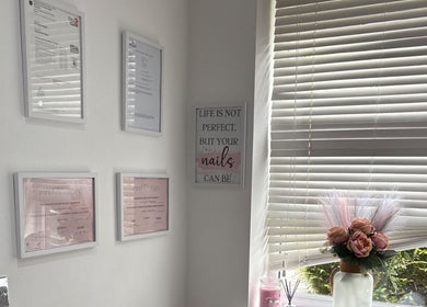 Ella Louise Beautyy in Rochdale, England, GB features chic decor with framed certificates and elegant flowers.