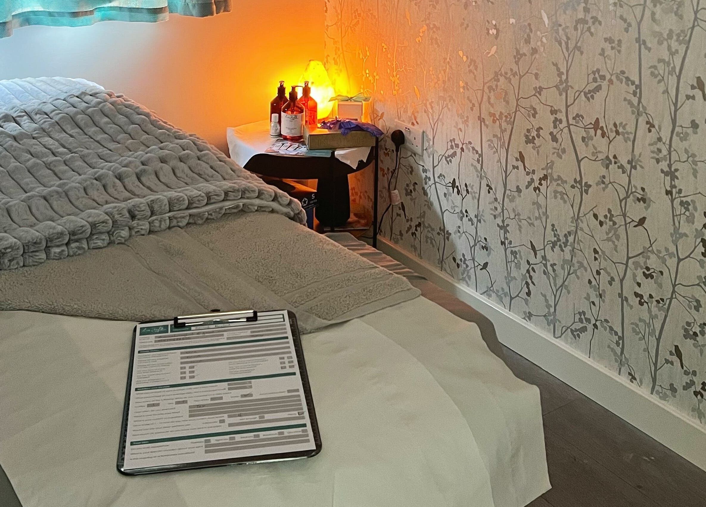 Relaxing treatment room at YG Beauty, Middlesbrough, GB with cozy bed and soft lighting.