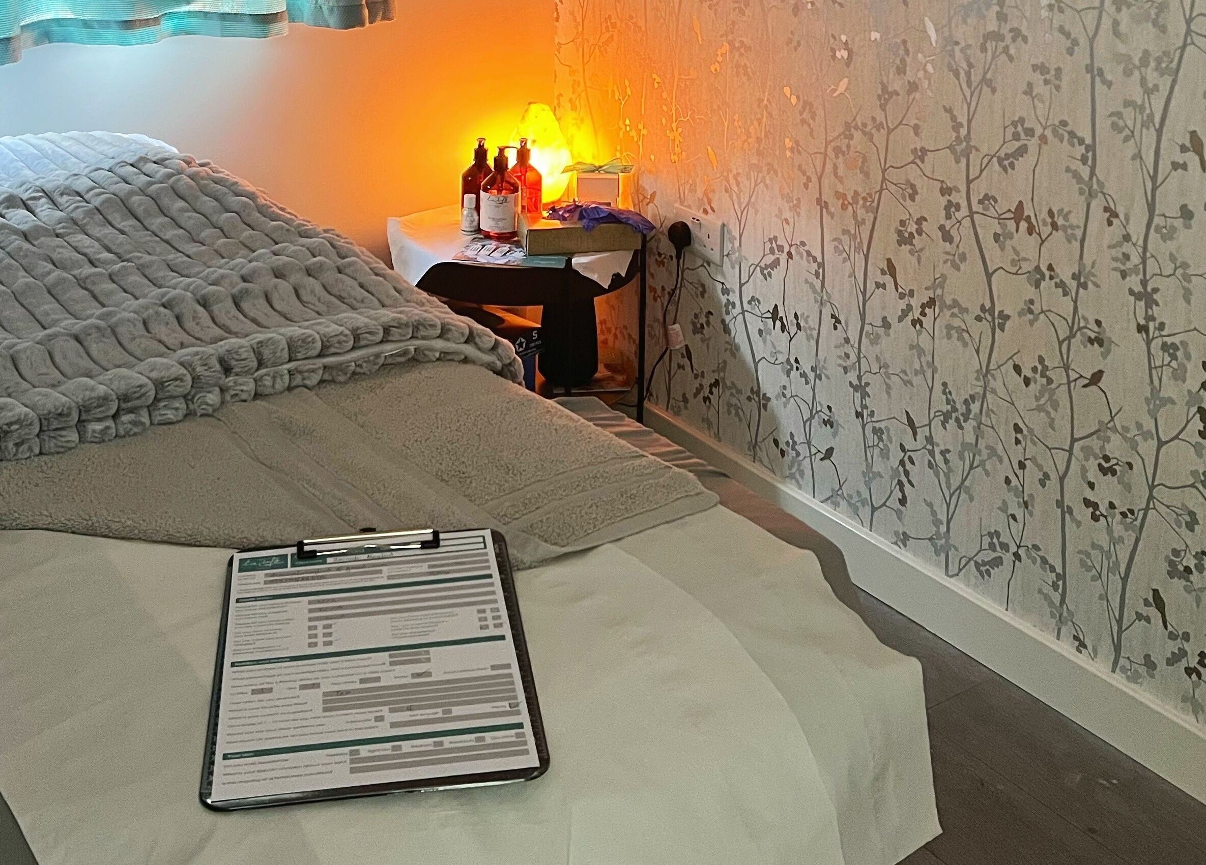 Relaxing treatment room at YG Beauty, Middlesbrough, GB with cozy bed and soft lighting.