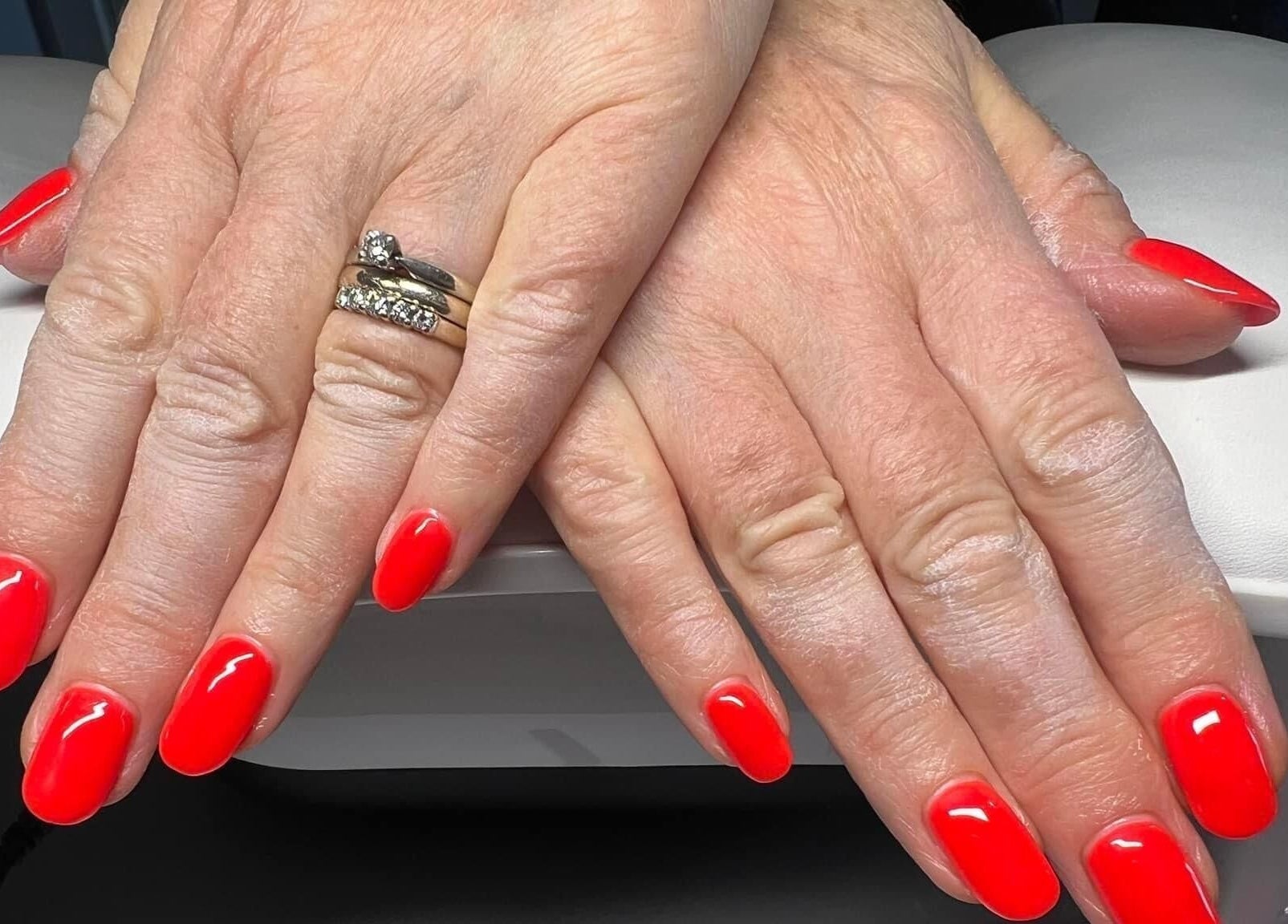Bright red manicured nails at YG Beauty, Middlesbrough, GB, showcasing expert nail care services.
