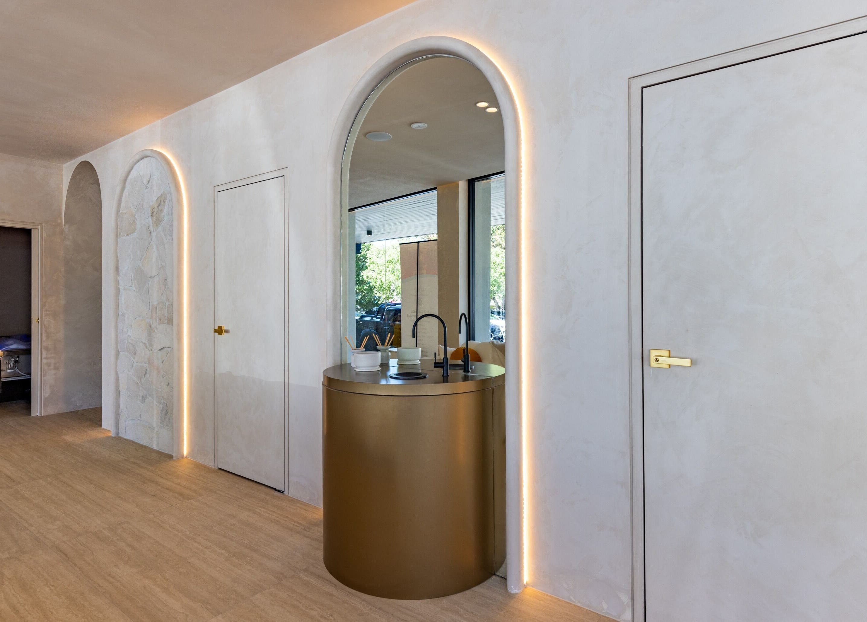 Elegant interiors of Elite Body Recovery and Wellbeing in Maroubra, New South Wales, featuring a golden archway.