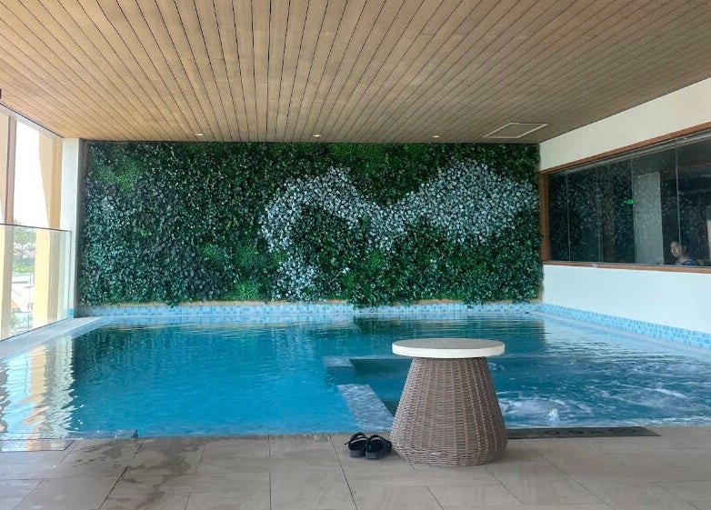 Tranquil pool area at Maia Spa by Fusion, Vũng Tàu, Bà Rịa - Vũng Tàu, VN, with a lush green wall.