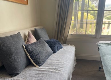 Cozy seating and massage table at Holistic Massage and Facial for Women, Healesville, Victoria, AU.