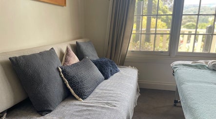 Cozy seating and massage table at Holistic Massage and Facial for Women, Healesville, Victoria, AU.