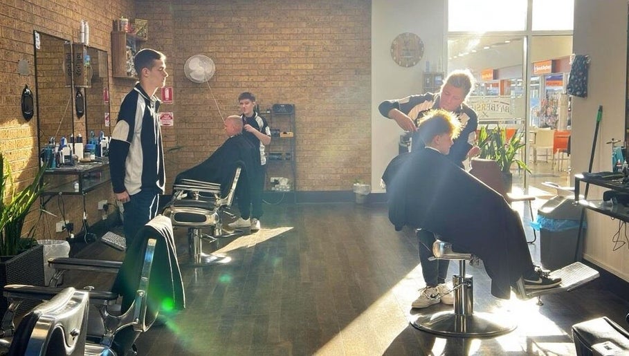 Professional barbers at Craig’s Barbershop, Thornton, New South Wales, AU, giving haircuts in bright sunlight.