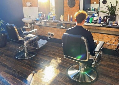 Modern interior of Craig’s Barbershop in Thornton, NSW, AU with two barber chairs and sunlight streaming in.