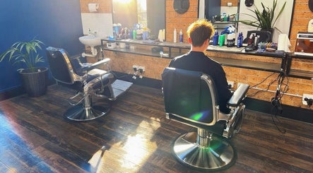Modern interior of Craig’s Barbershop in Thornton, NSW, AU with two barber chairs and sunlight streaming in.