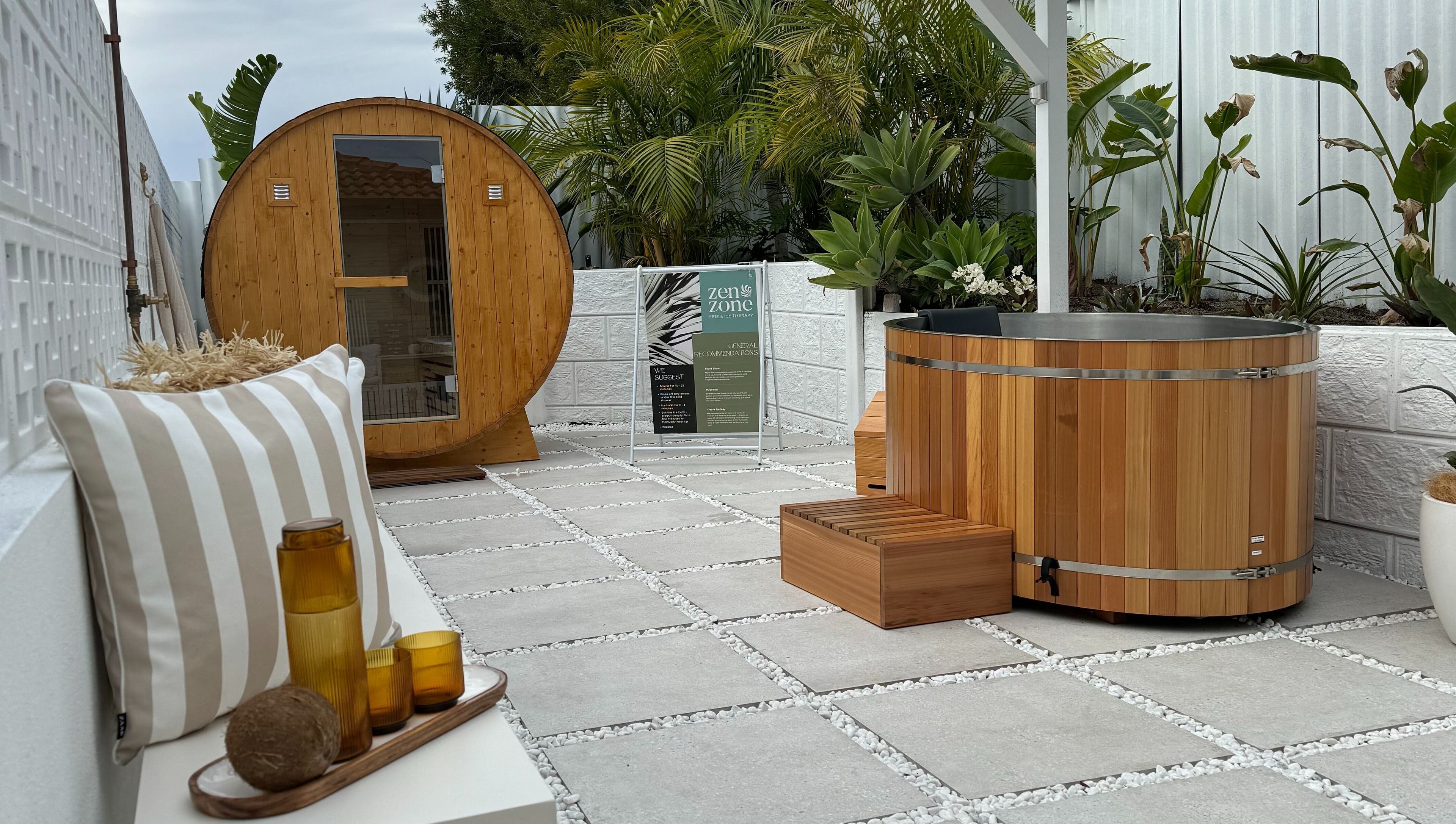 Outdoor spa area at Zen Zone Perth, Beldon, Western Australia, AU, with a barrel sauna and hot tub.