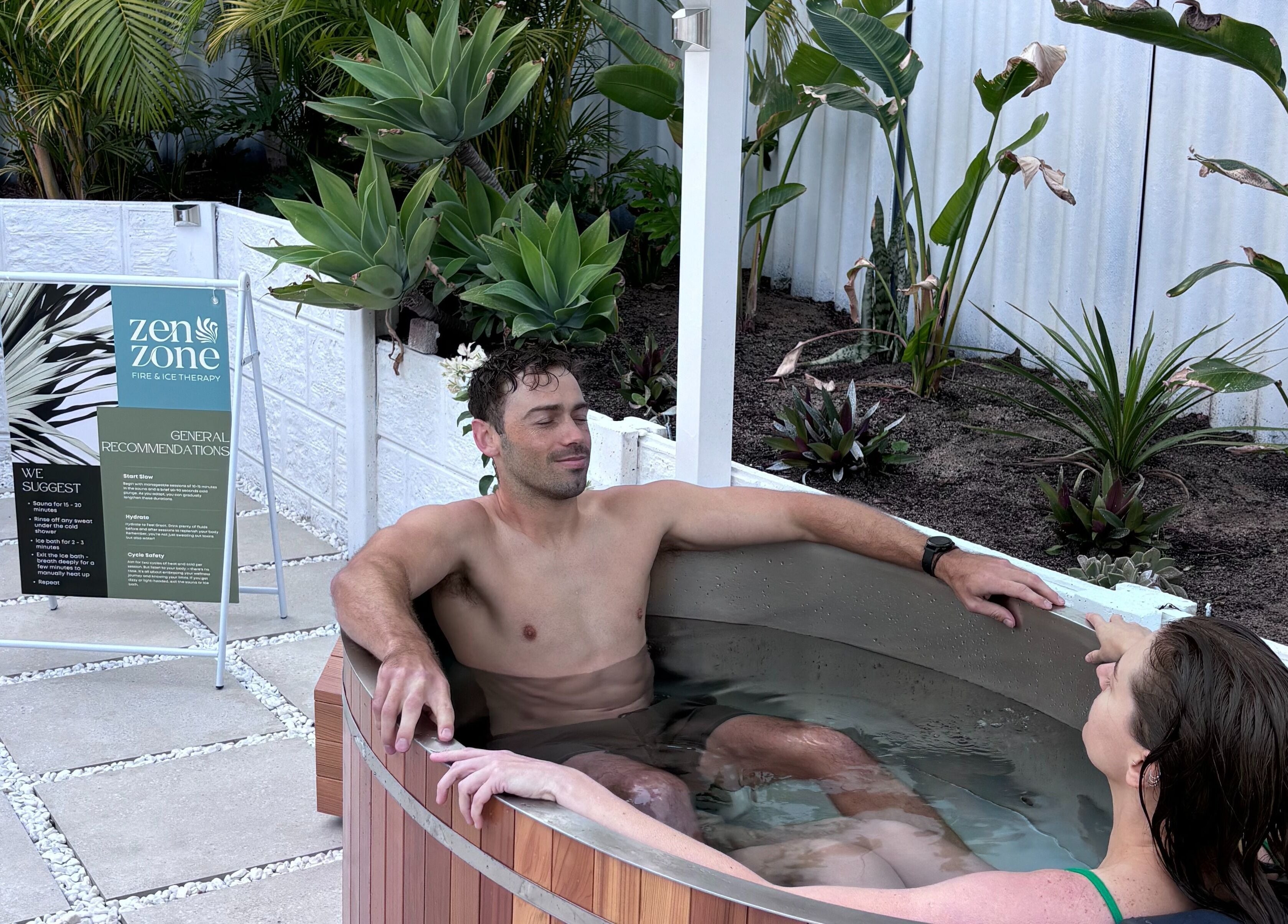 Guests enjoy a relaxing soak at Zen Zone Perth in Beldon, Western Australia, AU, surrounded by lush greenery.