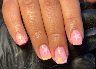 Sparkling pink nails with star designs at BIABI Nails & Beauty, Glasgow, Scotland, GB.