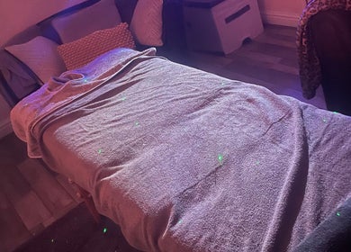 Cozy massage setup at Relax and Renew - Mobile Massage Service in Bolton, England, GB with ambient lighting.