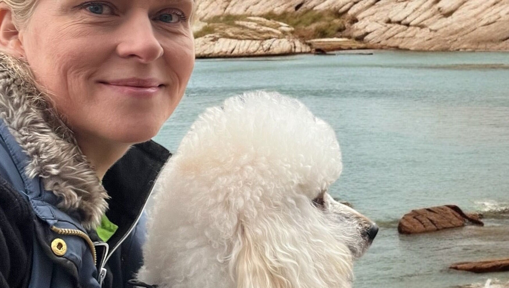 Woman with poodle at Hönö Hundfrisör by the sea, Hönö, Västra Götalands Län, SE.