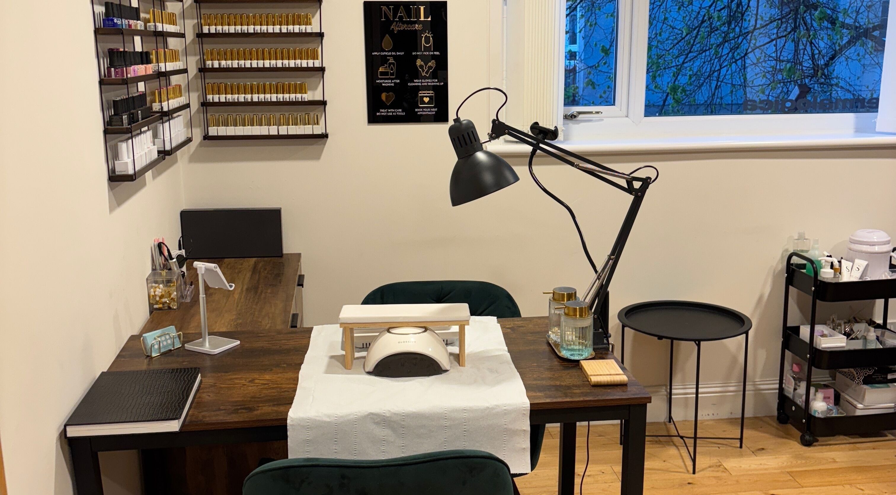 Elegant nail station at Beauty by Keri, Airdrie, Scotland, GB, featuring a modern lamp and manicure supplies.