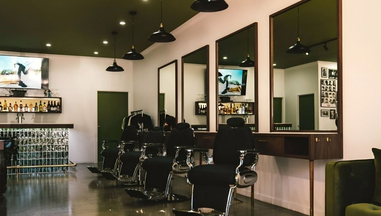 Interior of Nine Lives Barbershop in Paradise Point, Queensland, AU with stylish chairs and decor.
