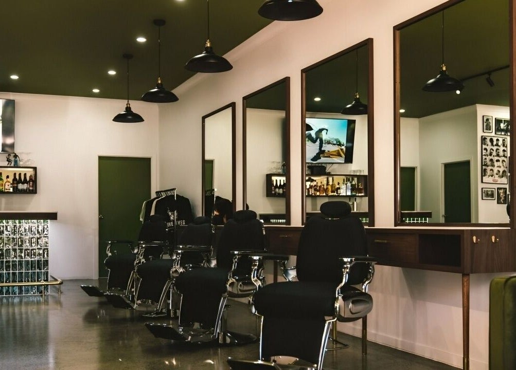Interior of Nine Lives Barbershop in Paradise Point, Queensland, AU with stylish chairs and decor.
