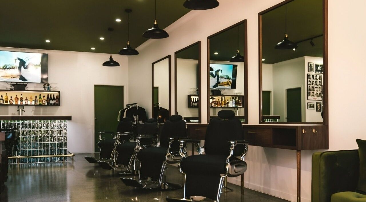 Interior of Nine Lives Barbershop in Paradise Point, Queensland, AU with stylish chairs and decor.