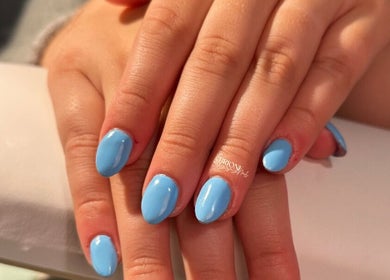 Sky blue nails by Brioni Nails at Prince Albert, Saskatchewan, CA showcasing a sleek manicure.