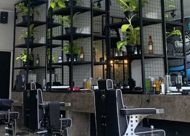 Modern interior of Social Animals Barbershop & Tattoo Parlour (Canggu) with greenery and stylish decor, Bali, ID.