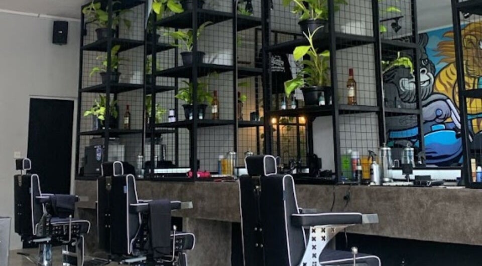Modern interior of Social Animals Barbershop & Tattoo Parlour (Canggu) with greenery and stylish decor, Bali, ID.