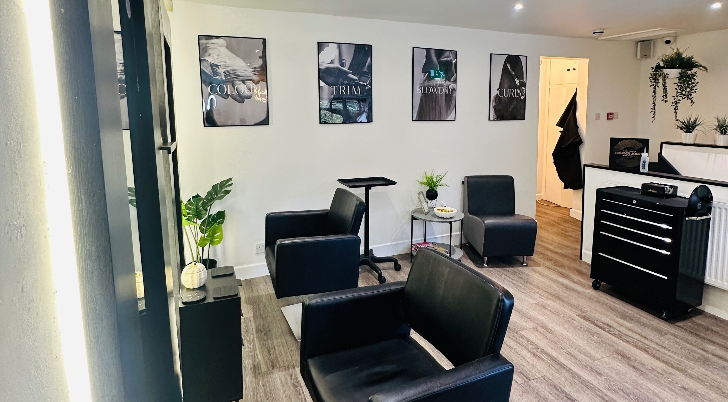 Modern interior of Hair by Hayley Louise - The Haven in Blackburn, England, GB, showcasing sleek black chairs and decor.