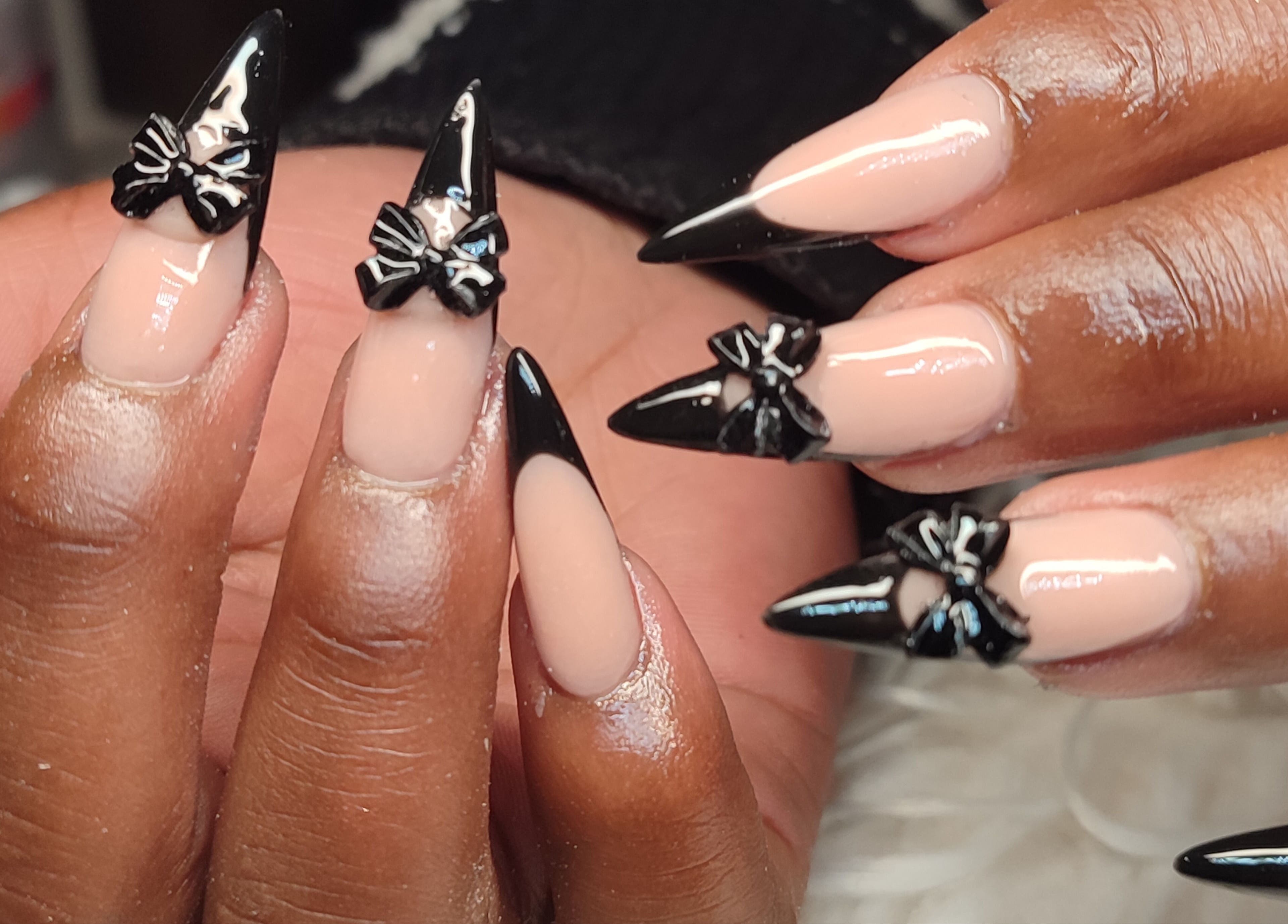 Stylish black-tipped nails with bows at Tiamkupinails Woodstock, Cape Town, Western Cape, ZA.