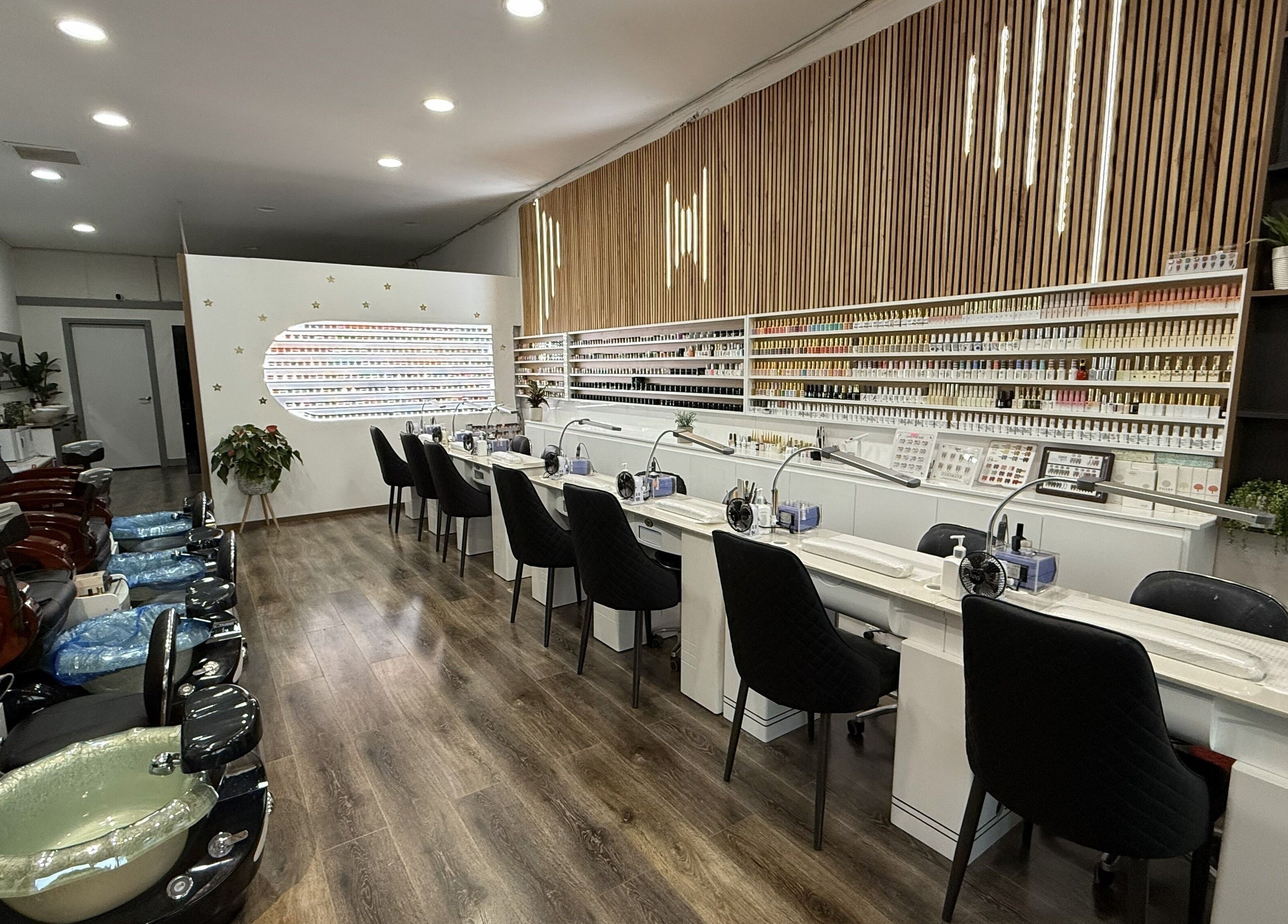 Interior of Lee Nails & Beauty in Melbourne, Victoria, AU featuring manicure stations and pedicure chairs.