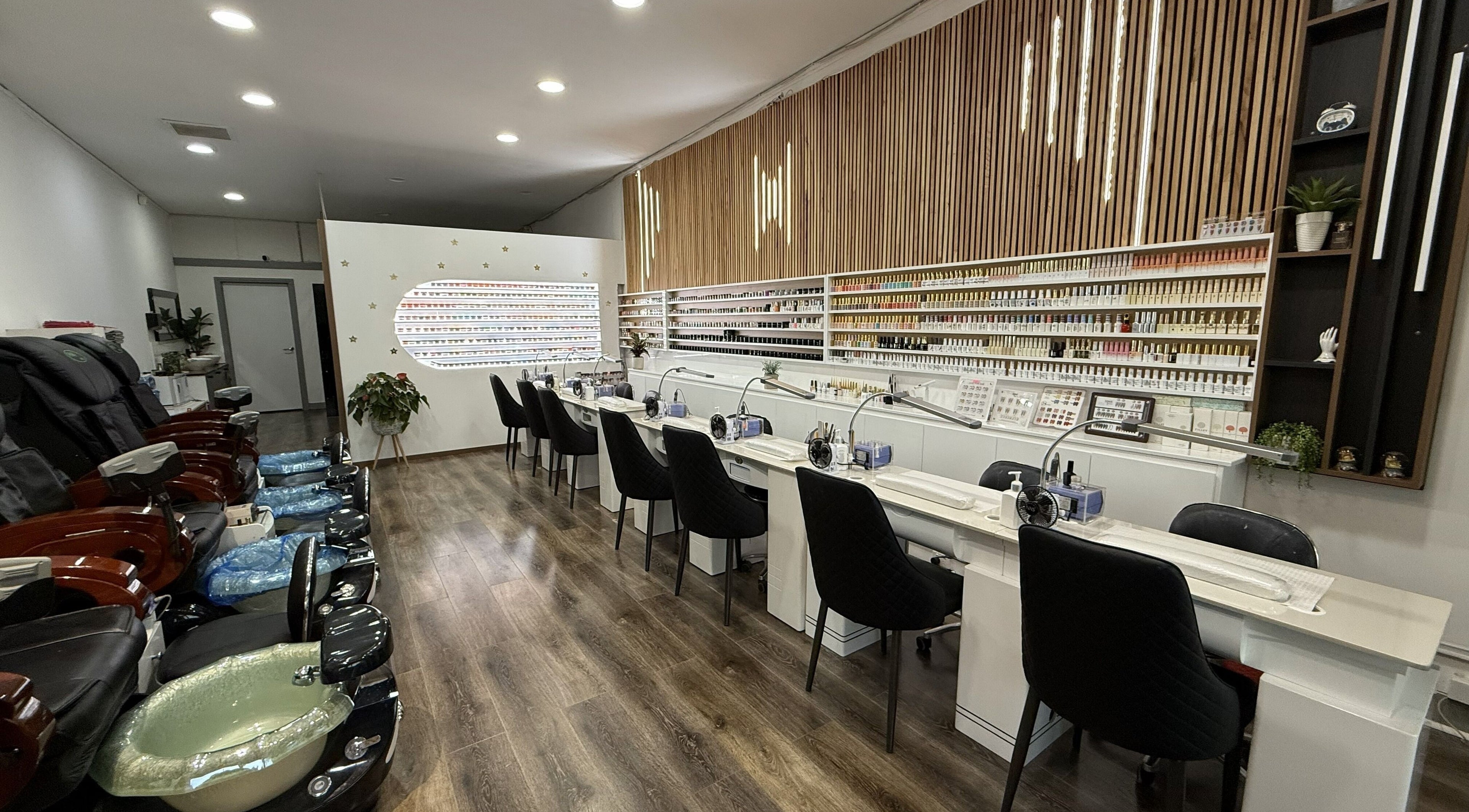 Interior of Lee Nails & Beauty in Melbourne, Victoria, AU featuring manicure stations and pedicure chairs.