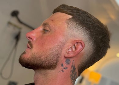 Man with a sharp fade haircut and rose tattoo at Winding Creative, Canterbury, England, GB.