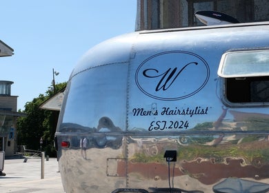 Silver hairstylist trailer at Winding Creative, Canterbury, England, GB, offering men's hair services.