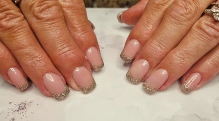 Elegant glittery tipped nails at Jennie's Gels & Beauty, Pencoed, Wales, GB, perfect for a glam look.