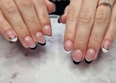 Stylish French manicure at Jennie's Gels & Beauty, Pencoed, Wales, GB featuring black and white tips.